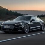 Audi e Tron GT electric car driving on a mountain road.